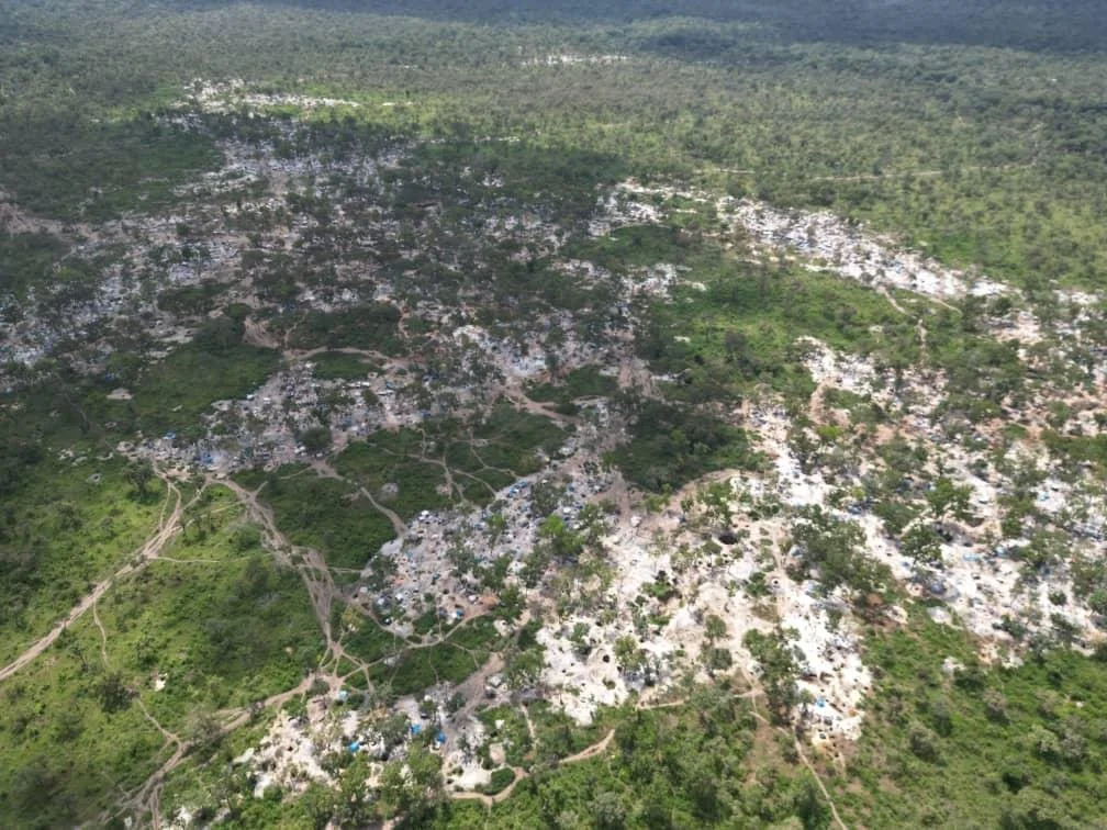 Aerial view of an extensive mineral workings area amid green bushland